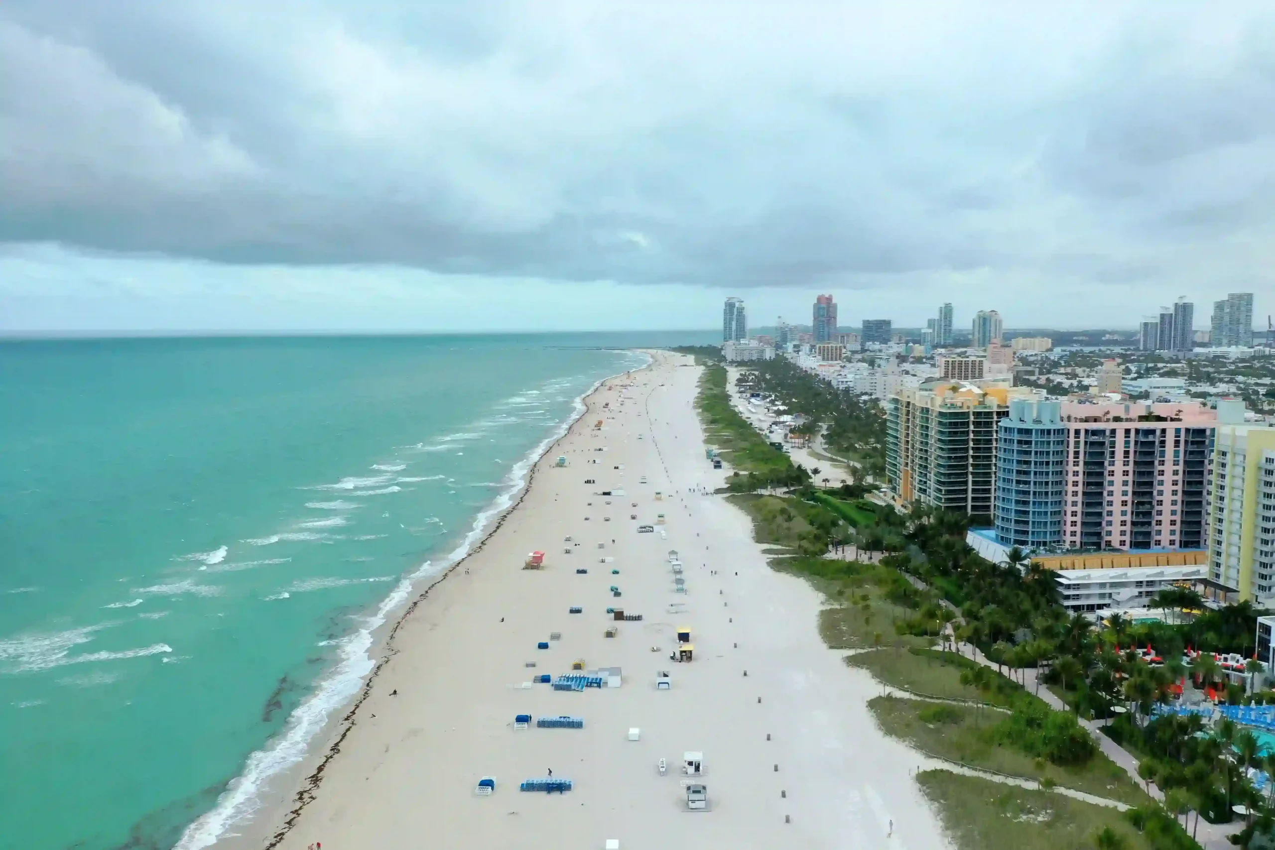 Sunny Miami Beach with turquoise Atlantic waters and white sandy shoreline.
