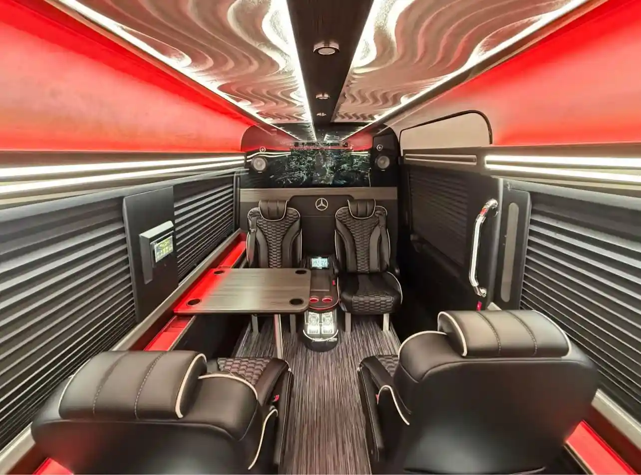 Luxury limousine interior from Car services Miami with sofa seats, ambient lighting, mini bar, DJ system, and part of our premium chauffeur fleet.