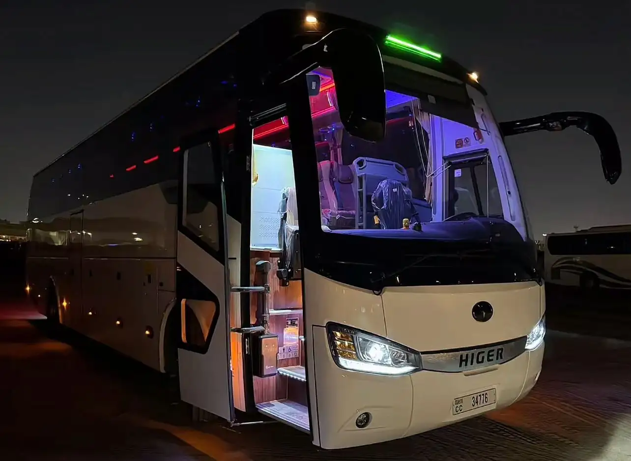 Luxury party bus from Car services Miami featuring a premium chauffeur and modern fleet, parked with doors open and disco lights ready for guests.