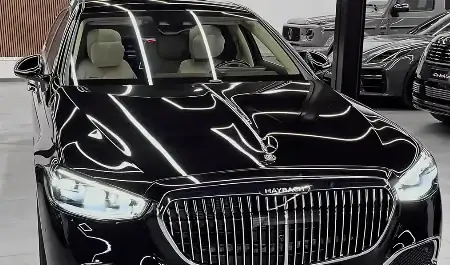 A black Mercedes Maybach featuring futuristic design elements and advanced technology.
