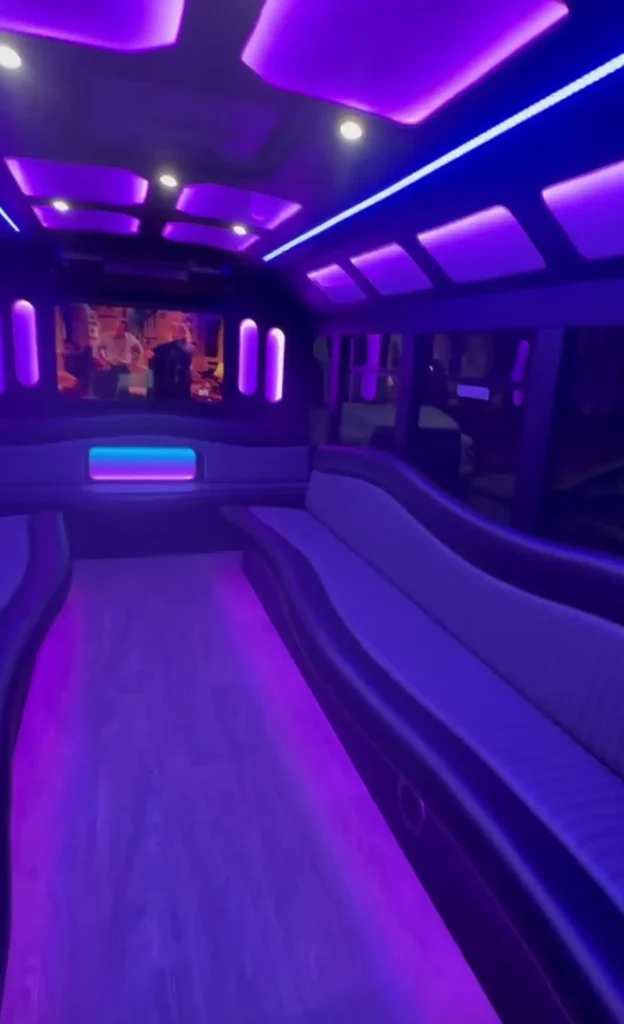 Black limousine luxury interior with ambient lighting and small club style setup inside for VIP travel